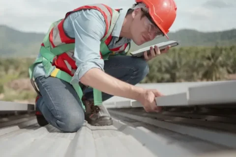 Man performing a roofing inspection in North Carolina.