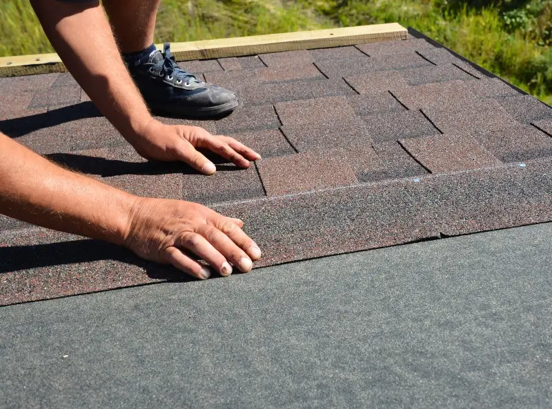 man replacing roof