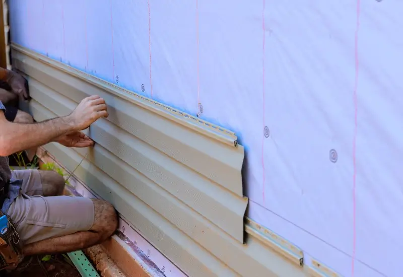 Man installing new siding on house in NC.